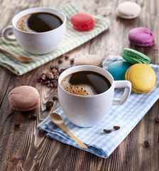 Cup of coffee and french macaron.