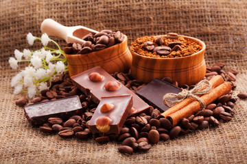 Coffee beans in wooden bowl on burlap tablecloth, rustic style