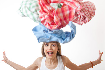 woman throws a pile of clothes, isolated on white