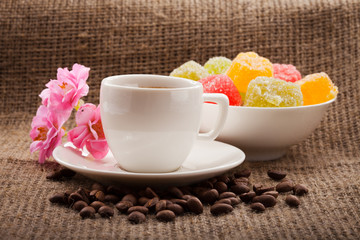 Nice breakfast with cup of coffee, flowers, blank paper for text