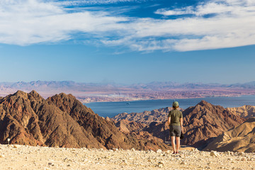 Young woman standing mountains bay. 