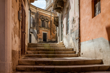 Fototapeta na wymiar Stairs Through Alley in Sicilian City of Modica