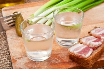 glass of vodka, cucumber and bacon