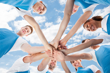 Professional Cleaners Piling Hands Against Sky