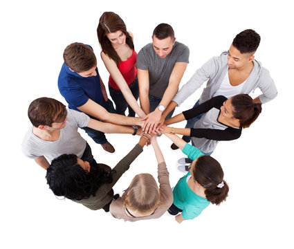 College Students Standing Hands Against White Background