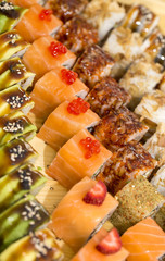 Japanese rolls in a restaurant with fish and vegetables