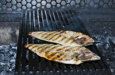 cooking fish on the grill in the restaurant