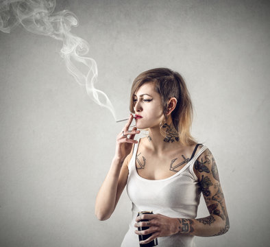 Tattoed girl smoking a cigarette