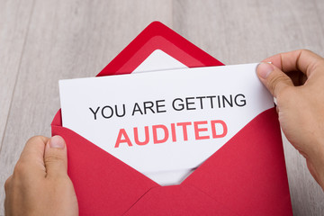 Hand Holding You Are Getting Audited Card