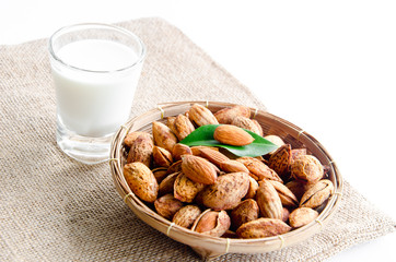 almonds milk with almonds on weave basket.