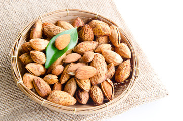 Almonds in basket on brown sack background