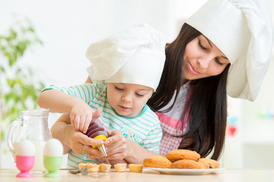 Mother and kid girl making cookies
