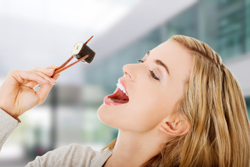 Woman eating sushi