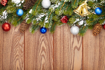 Christmas wooden background with snow fir tree and decor