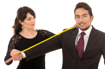 young woman tailor designer taking measures of client