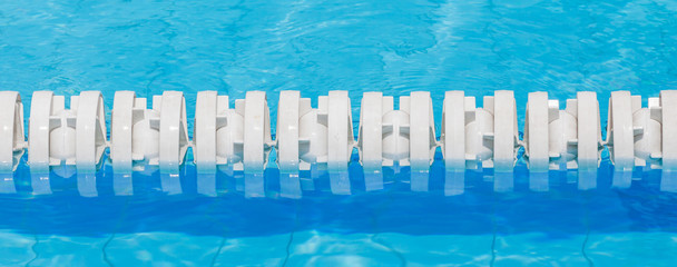 Closeup of white lane rope in swimming pool for competitions.