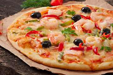 Pizza with shrimp, salmon and olives