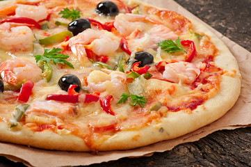 Pizza with shrimp, salmon and olives