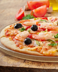 Pizza with shrimp, salmon and olives
