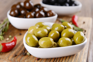 Different marinated olives on table close-up