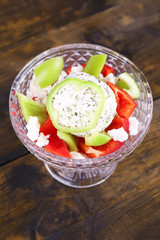 Cottage cheese with vegetables in piyala on wooden background