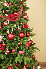 Fototapeta na wymiar Decorated Christmas tree in room closeup