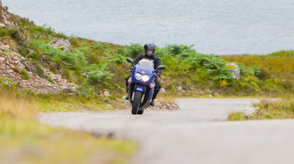 Fototapeta premium Motorcyclist in the Scottish Highlands