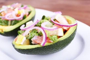 Tasty salad in avocado on plate table close-up