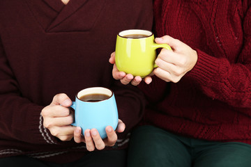 Loving couple with hot drinks