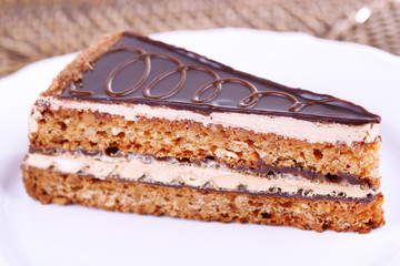 Delicious chocolate cake on plate on table close-up
