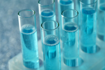 Test-tubes with liquid on color background