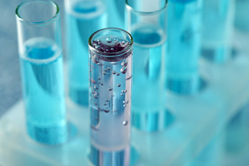 Test-tubes with liquid on color background