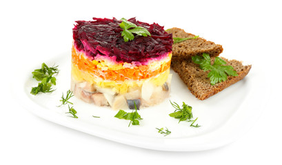 Russian herring salad on plate isolated on white