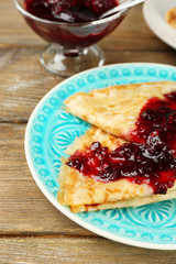 Plate of delicious pancakes with berry jam