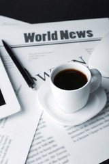 On-line news concept. Computer mouse, PC tablet, cup of coffee
