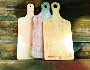 Empty cutting boards on wooden background