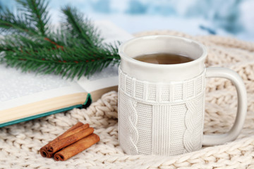 Obraz na płótnie Canvas Cup of tea with book on table close-up