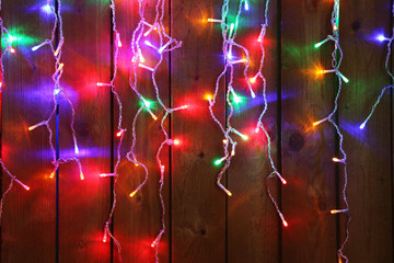 Christmas lights garland on wooden background