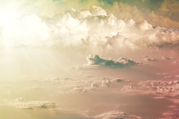 field with large clouds and sunlight