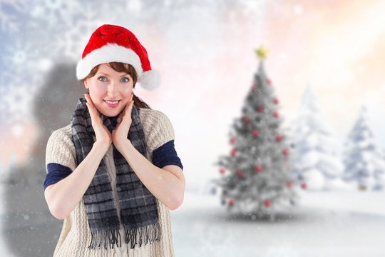 Composite image of smiling woman wearing santa hat