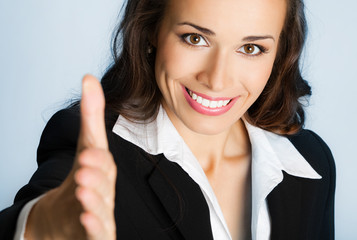 Business woman giving hand for handshake, over blue
