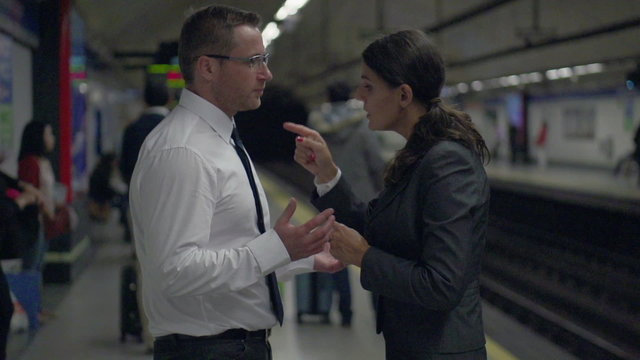 Businesspeople having quarrel on platform, slow motion,steadycam
