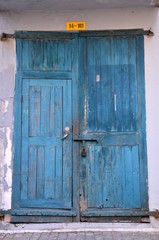 Blue wooden weathered door with padlock