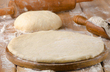 pizza dough on  wooden background