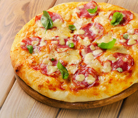 Fresh homemade salami pizza on  wooden  board