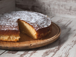 Sponge cake of lemon over wooden background