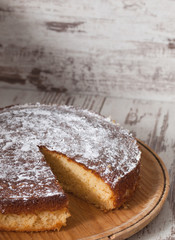 Sponge cake of lemon over wooden background