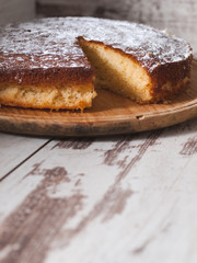 Sponge cake of lemon over wooden background