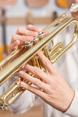 Fototapeta na wymiar Close up of fingers playing a trumpet