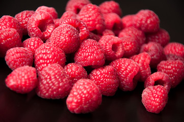 Beautiful raspberries on a black background